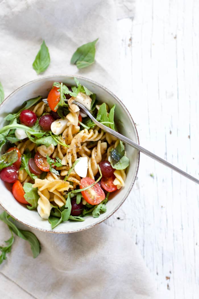 Fruity caprese pasta salad in a bowl
