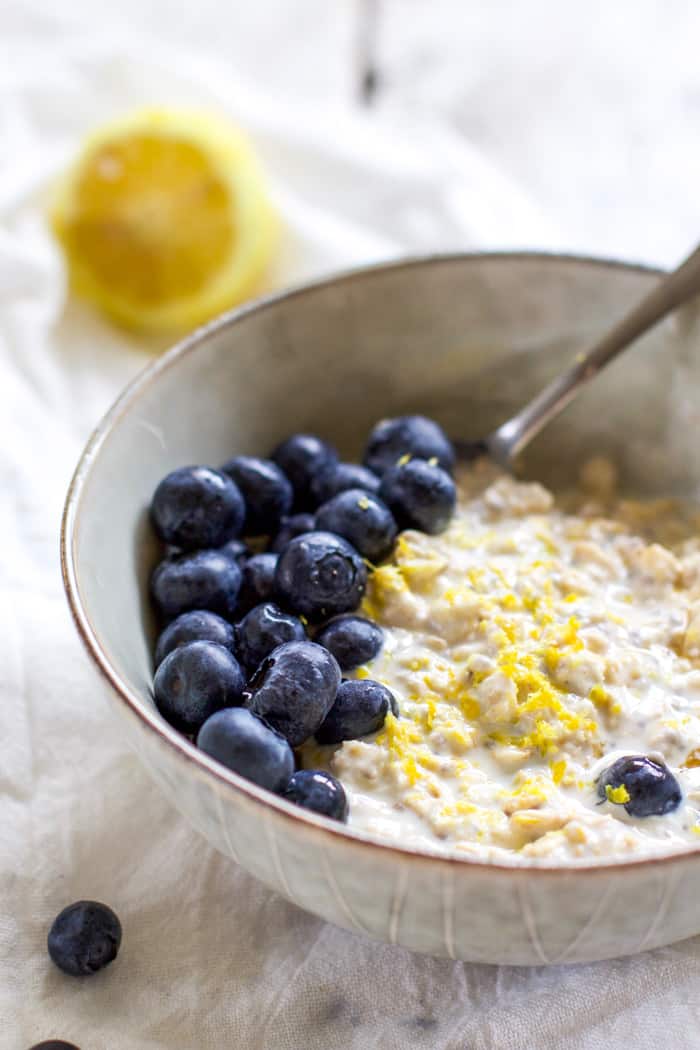 Blueberry lemon zest overnight oats in bowl with spoon