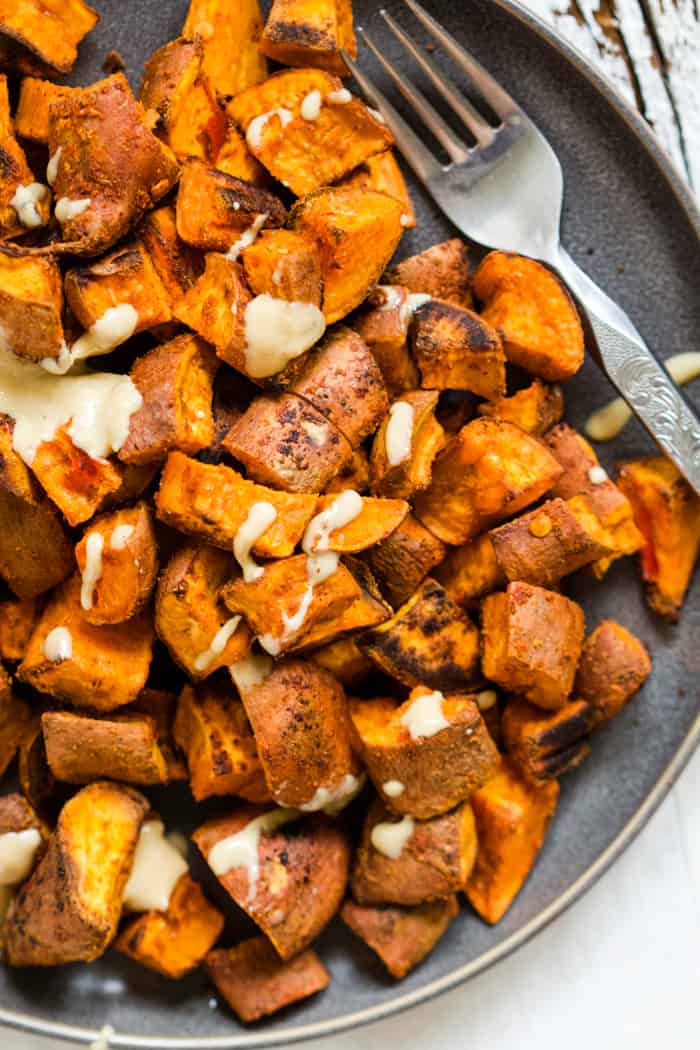 Harissa roasted sweet potatoes with tahini maple drizzle