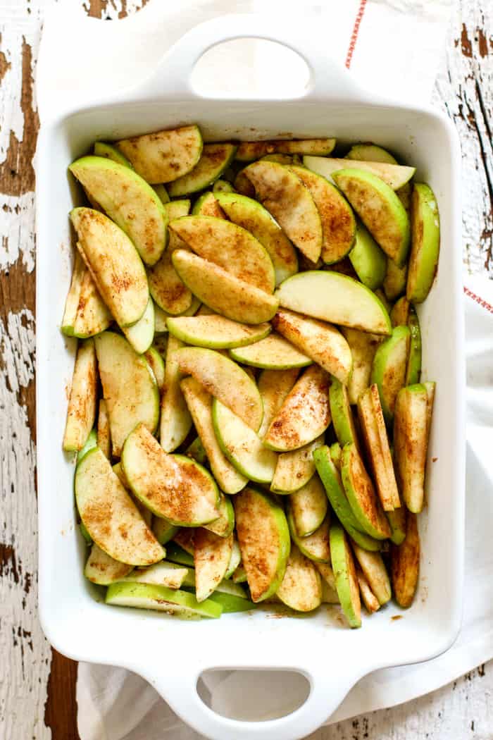 Apples with cinnamon in baking pan