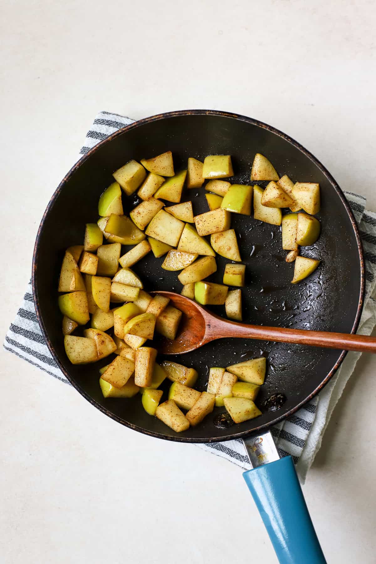 Sautéing diced apple in maple syrup and cinnamon.