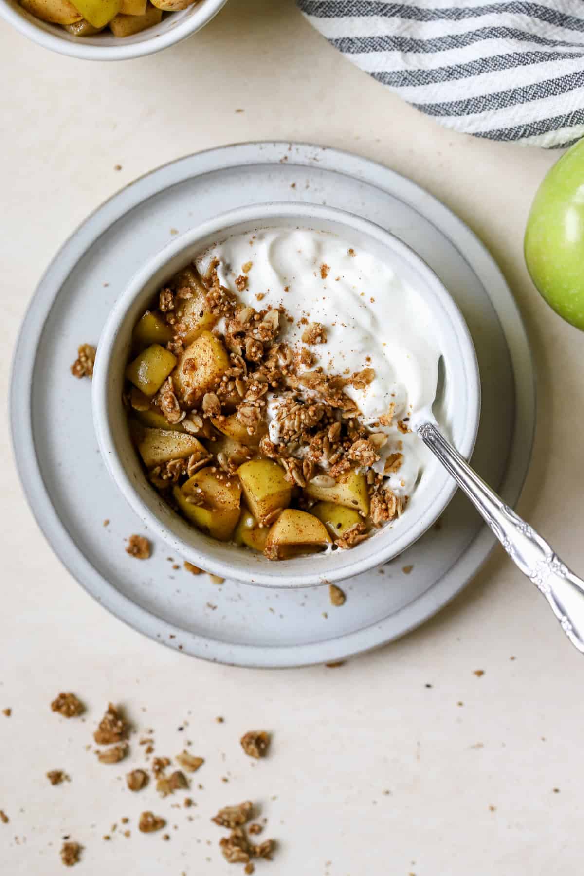 Apple pie yogurt bowl topped with granola and spiced apples.