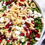 Kale, feta and pomegranate salad in a white bowl