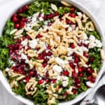 Kale, feta and pomegranate salad in a white bowl