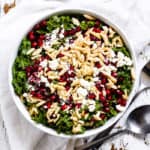 Kale, feta and pomegranate salad in a white bowl