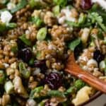 Wheat berry salad with wooden spoon.