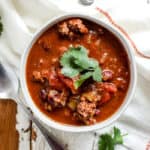 Bowl of classic beef chili with cilantro garnish