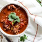 Bowl of classic beef chili with cilantro garnish