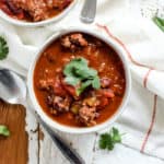 Bowl of classic beef chili with cilantro garnish