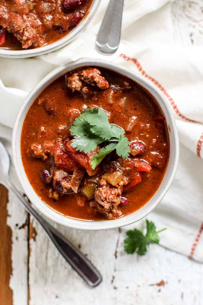 Bowl of classic beef chili with cilantro garnish