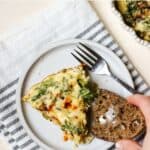 Slice of crustless kale pie on small plate with fork and toast.