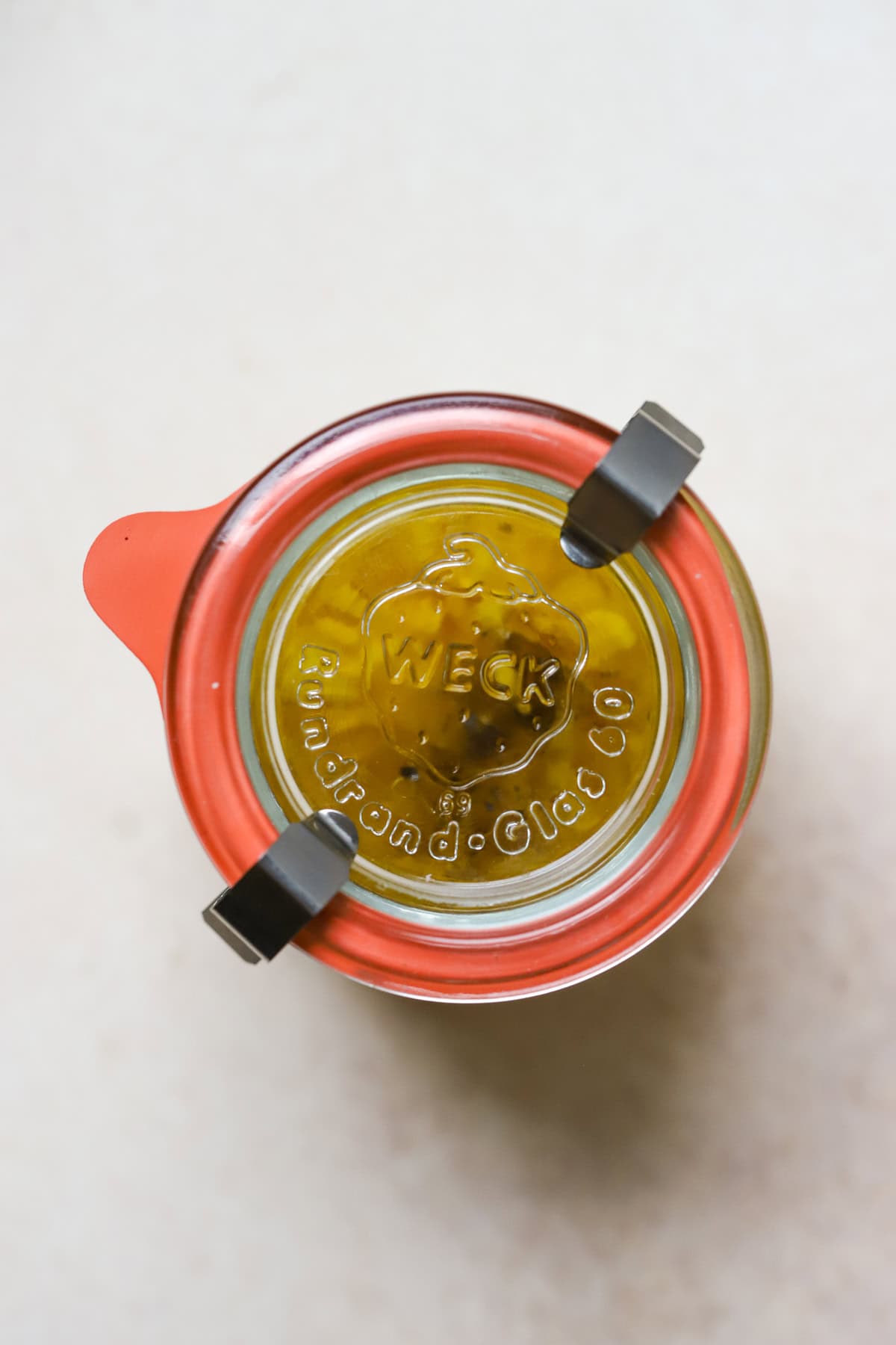 Simple lemon vinaigrette in sealed jar.