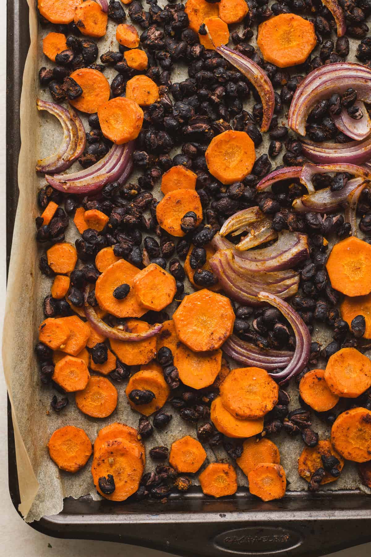 Cooked black bean and carrot taco filling on sheet pan.