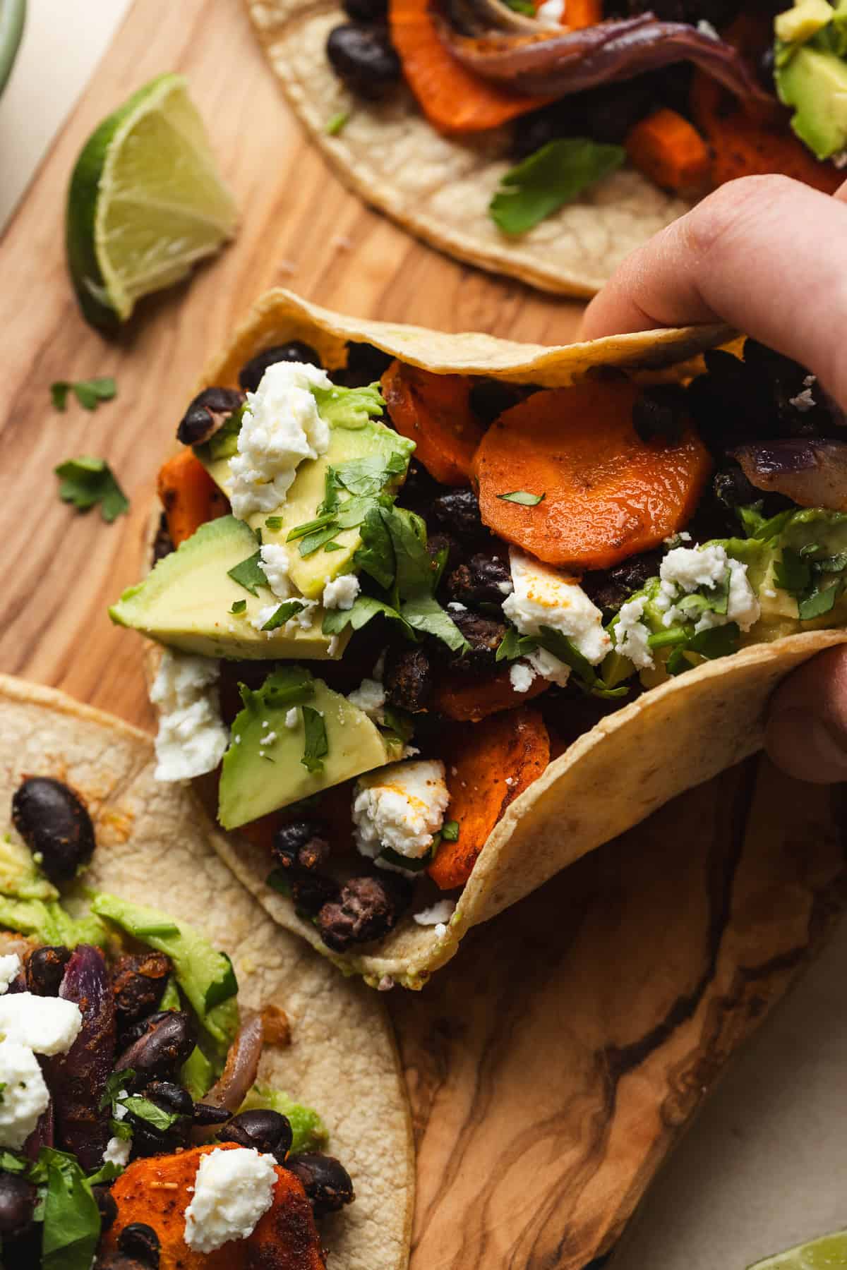 Roasted carrot and black bean taco topped with avocado and feta.