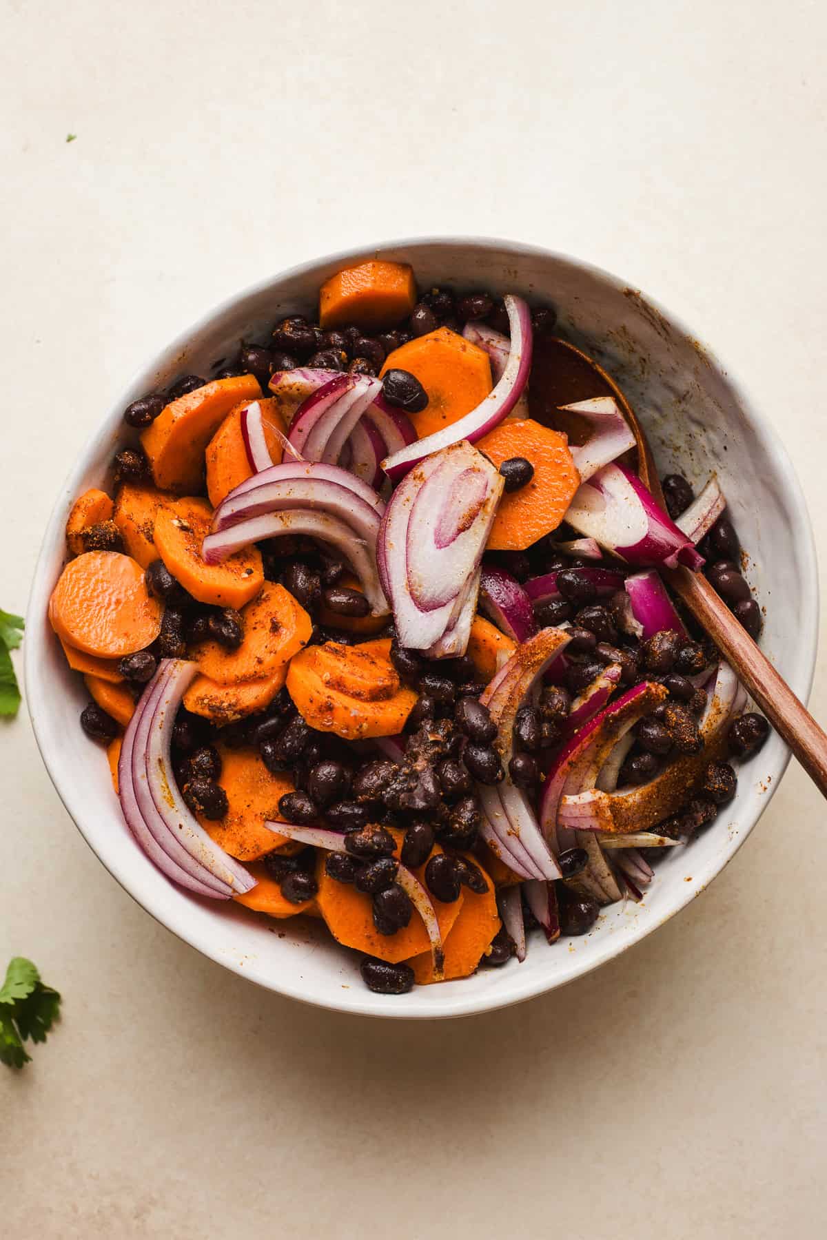 Bowl of taco-seasoned black beans, onions, and carrots.