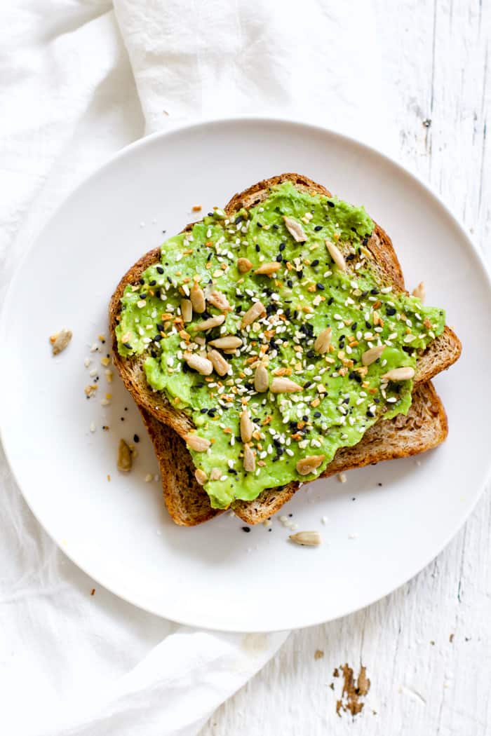 Everything Spice Avocado Toast - OMG, "everything" spice on avocado toast is genius! Sprouted grains bread, mashed avocado, "everything" spice blend, sunflower seeds. Simple and delicious! | rootsandradishes.com