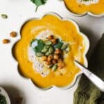 Thai butternut squash soup in a bowl with toppings.