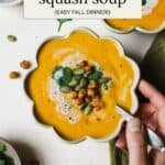 Thai butternut squash soup in a bowl with toppings.