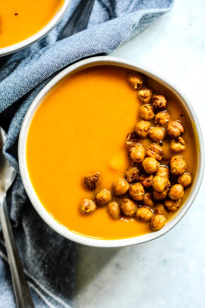 Bowl of thai-spiced butternut bisque with curry roasted chickpeas