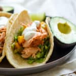 Smoky Salmon Butternut Tacos - Complete with lime crema! So simple, healthy, and flavorful. Sometimes you just need an easy weeknight meal during the busy holiday season. These tacos are it! Wild-caught salmon, smoked paprika, butternut squash, Brussels sprouts, lime crema. Come and try it out! | rootsandradishes.com