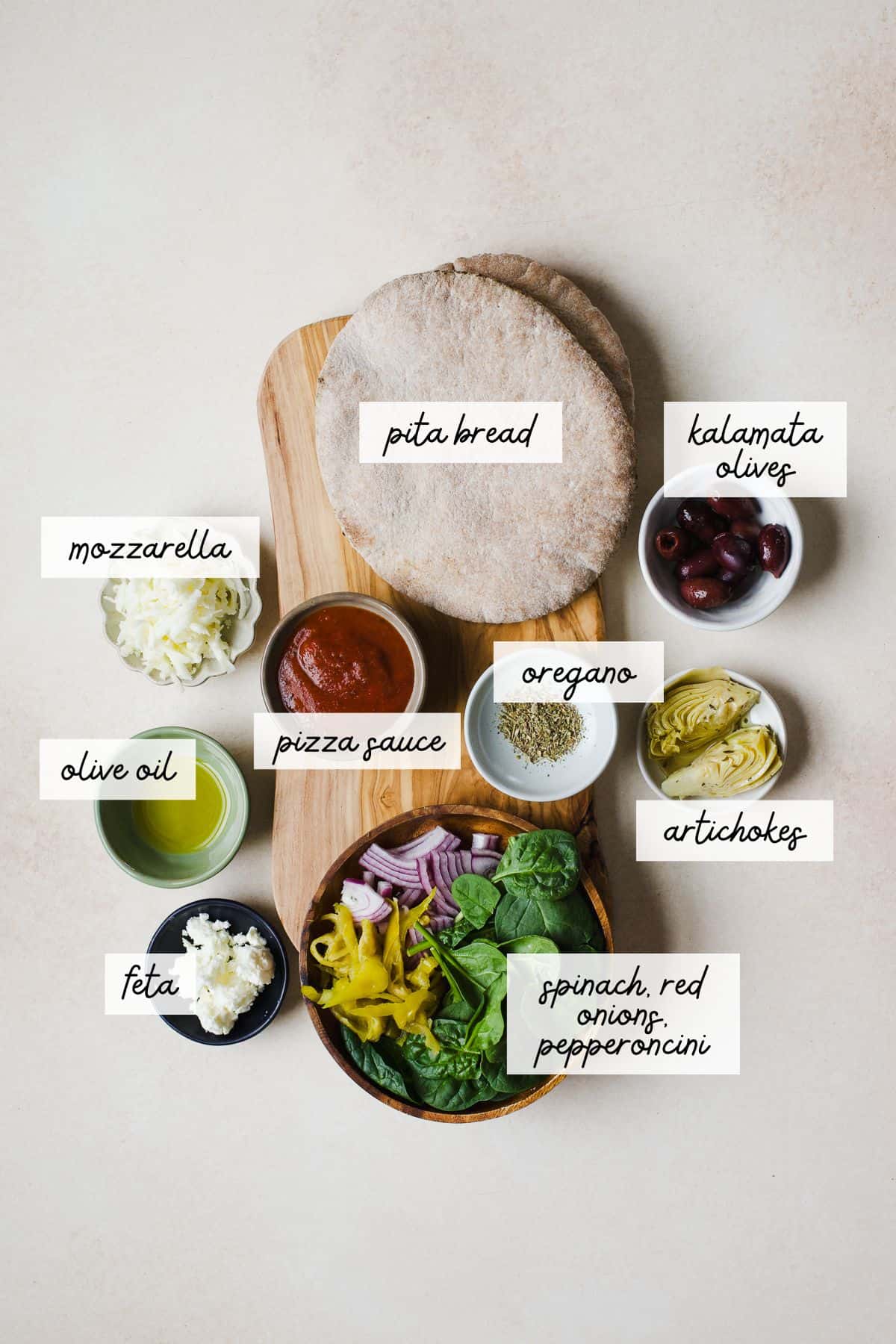 Ingredients needed to make Greek pita pizzas.