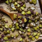 Pesto roasted potatoes on sheet pan with wooden turner.