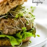 Two turkey pesto walnut burgers in basket lined with white parchment paper