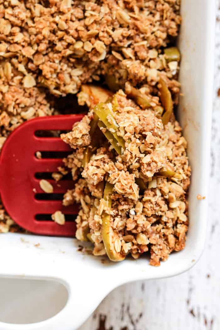 Apple crisp with almond butter topping in white baking pan