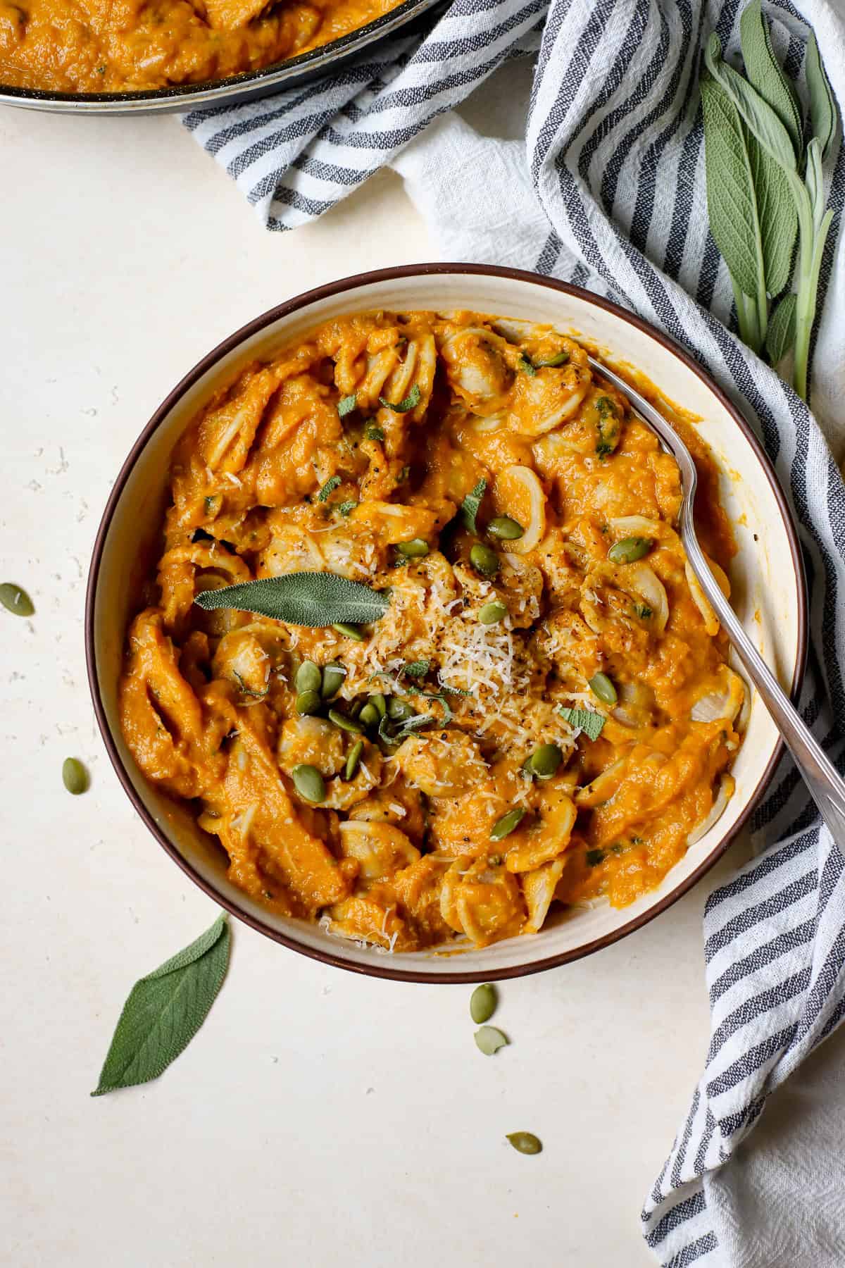 Creamy pumpkin pasta in bowl.