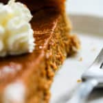 Slice of blender maple pumpkin pie with whipped cream