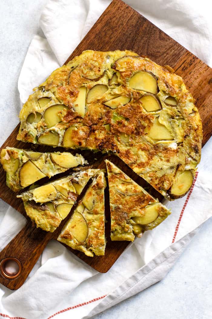 Spanish tortilla sliced on cutting board