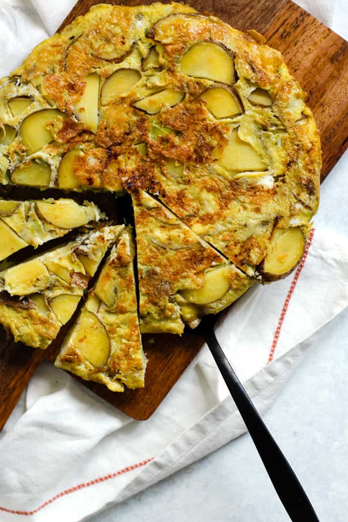 Spanish tortilla sliced on cutting board