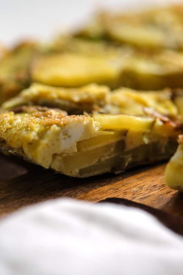 Spanish tortilla sliced on cutting board