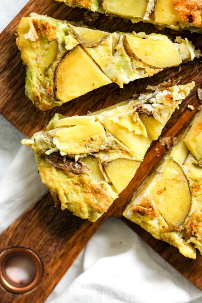 Spanish tortilla sliced on cutting board