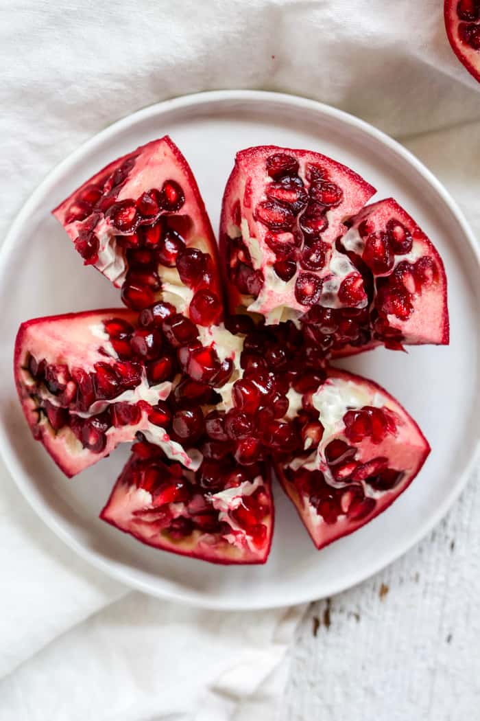 Pomegranate half sliced into sections