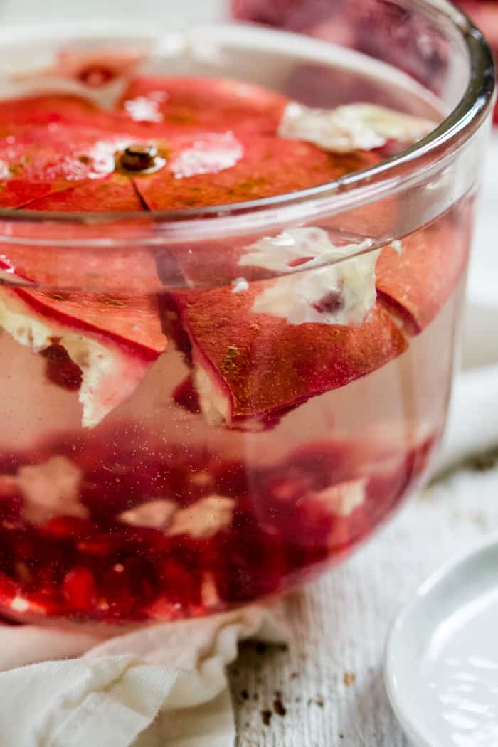 Pomegranate rind and arils in bowl of water