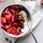 Blood orange maple pecan yogurt bowl in white bowl on white napkin