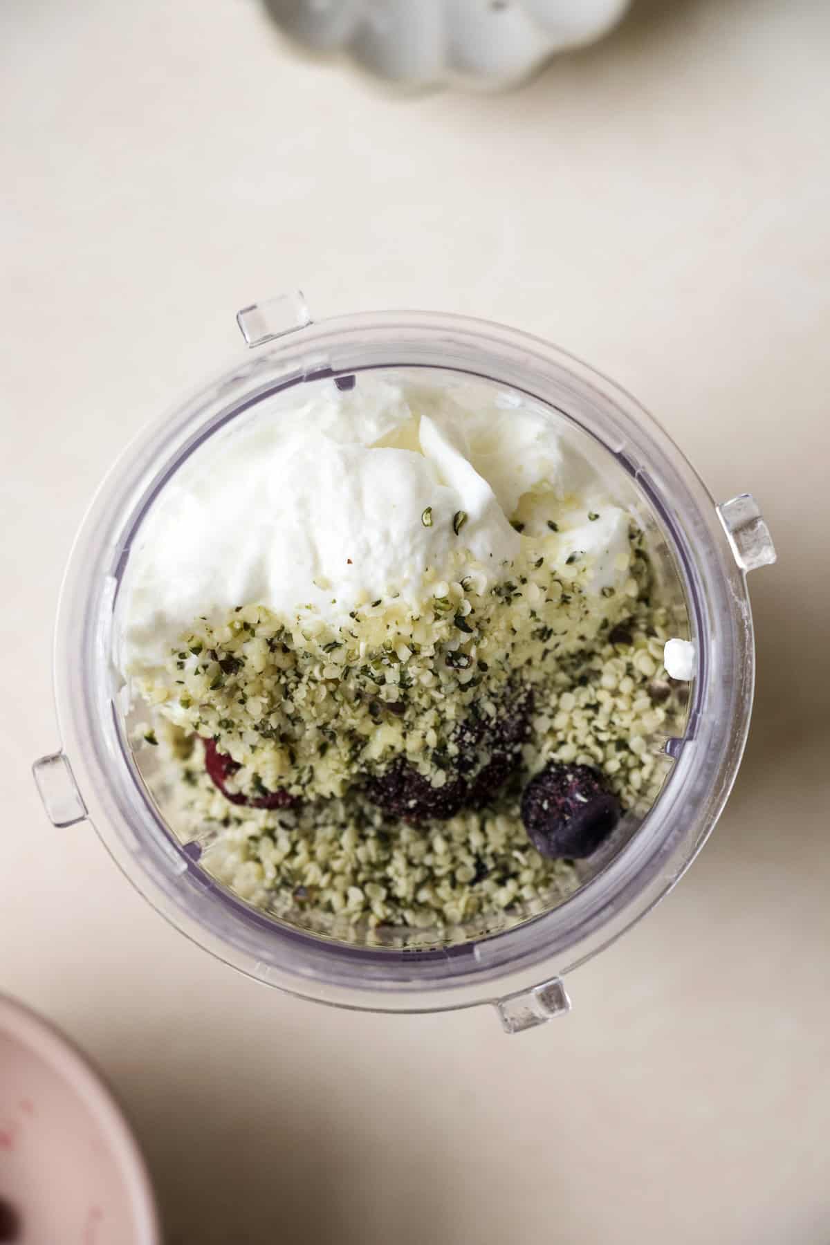 Berry protein smoothie ingredients in blender container, before blending.
