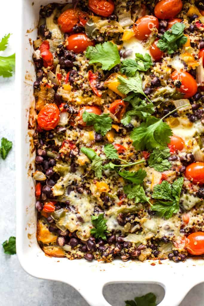 Cheesy black bean quinoa casserole in white baking dish