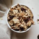 Cranberry almond granola in a white bowl.