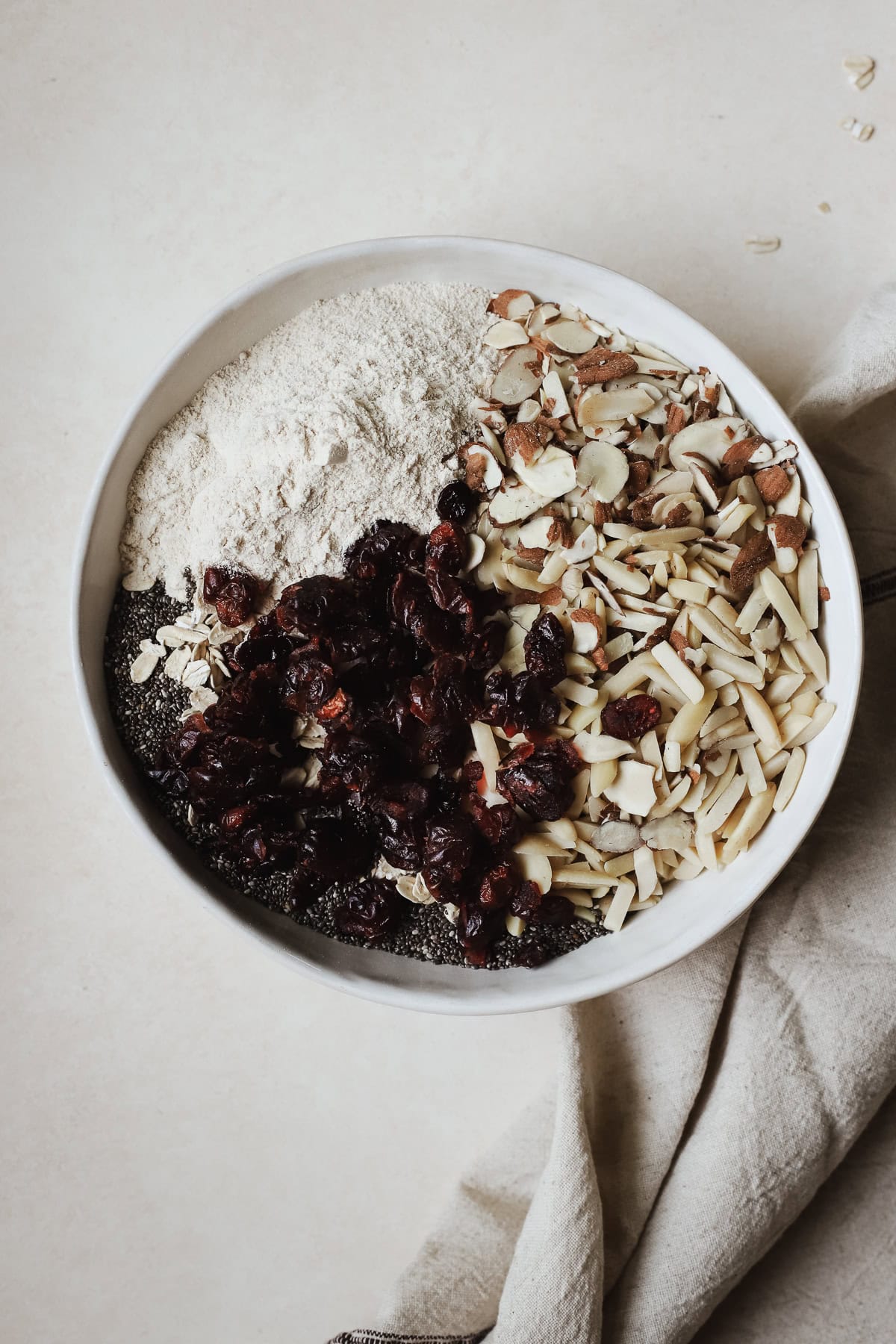 Dry granola ingredients combined in a bowl before being mixed.