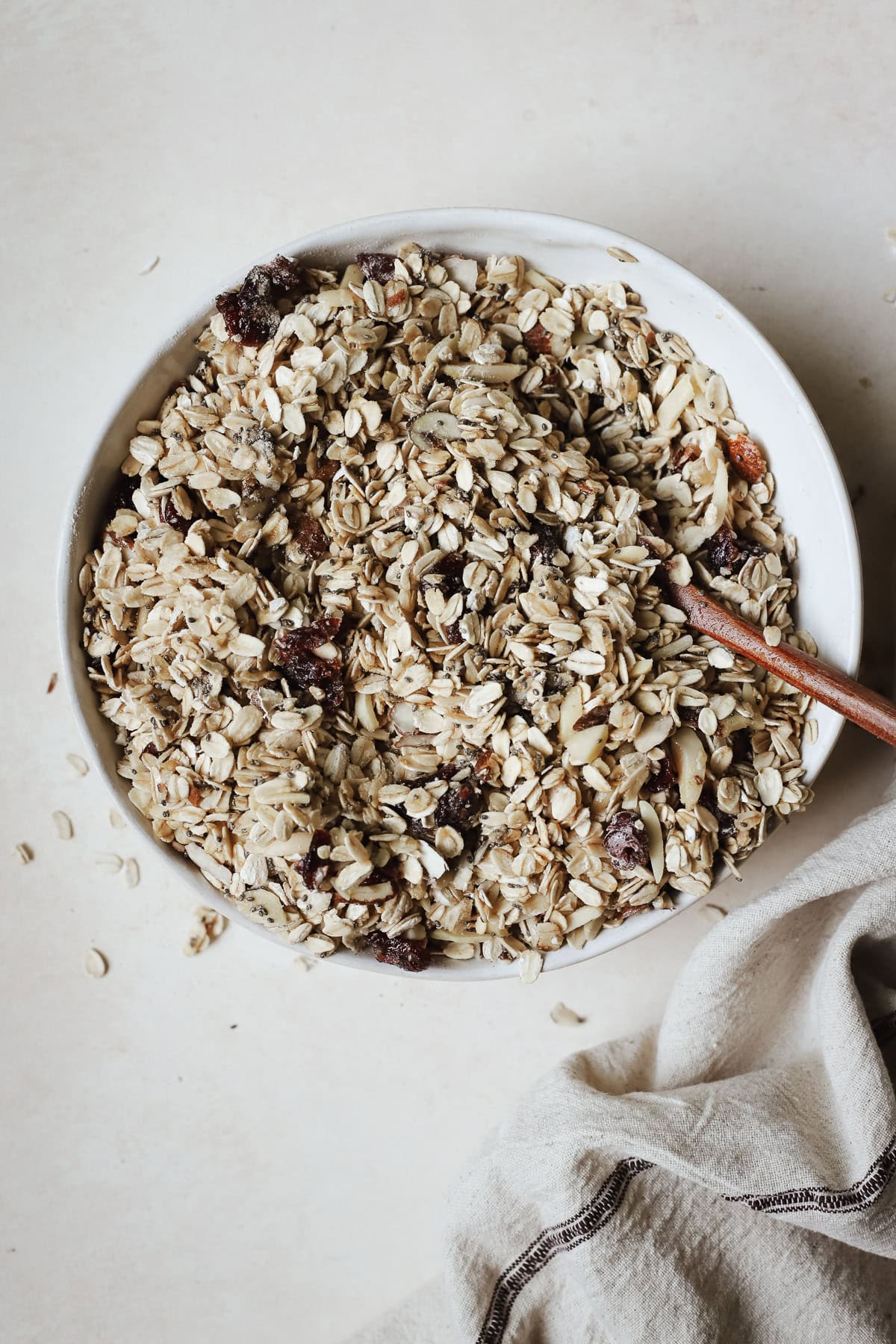Mixing granola ingredients together with a spoon.