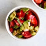 Strawberry avocado basil salsa in small white bowl