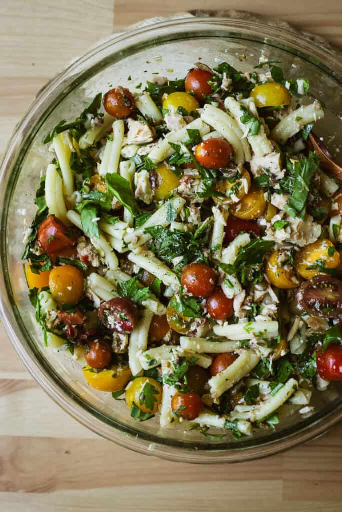 Olive tapenade pasta salad with canned tuna in a large bowl.