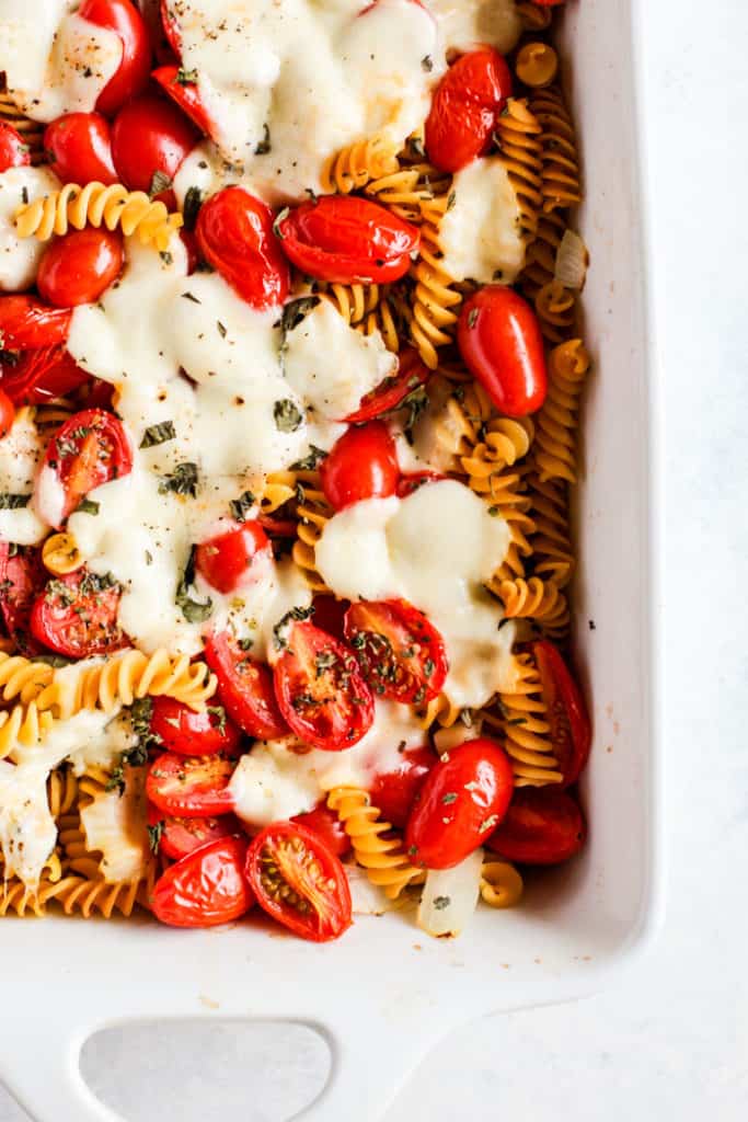 Simple caprese pasta bake in white ceramic dish