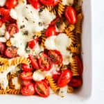 Simple caprese pasta bake in white ceramic dish