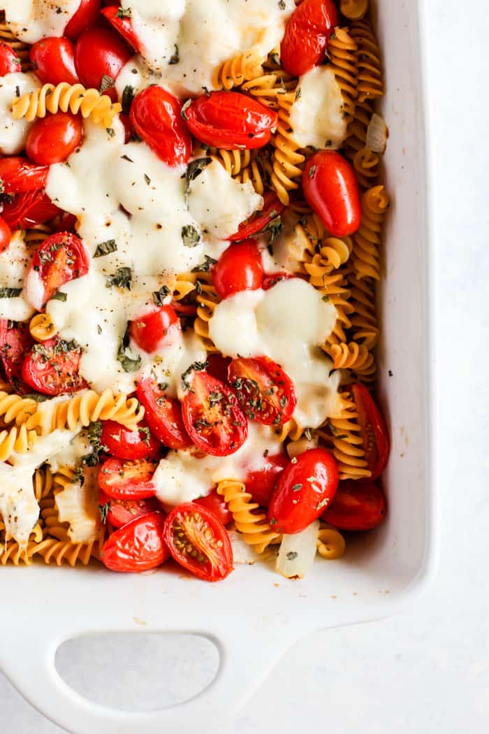 Simple caprese pasta bake in white ceramic dish