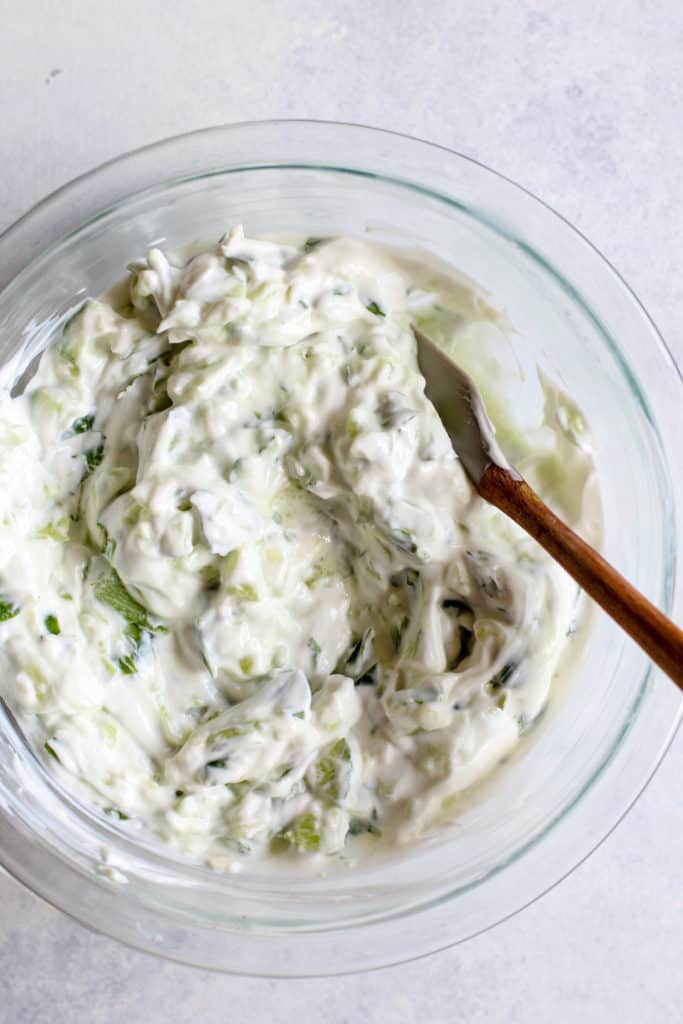 Tzatziki sauce in clear mixing bowl