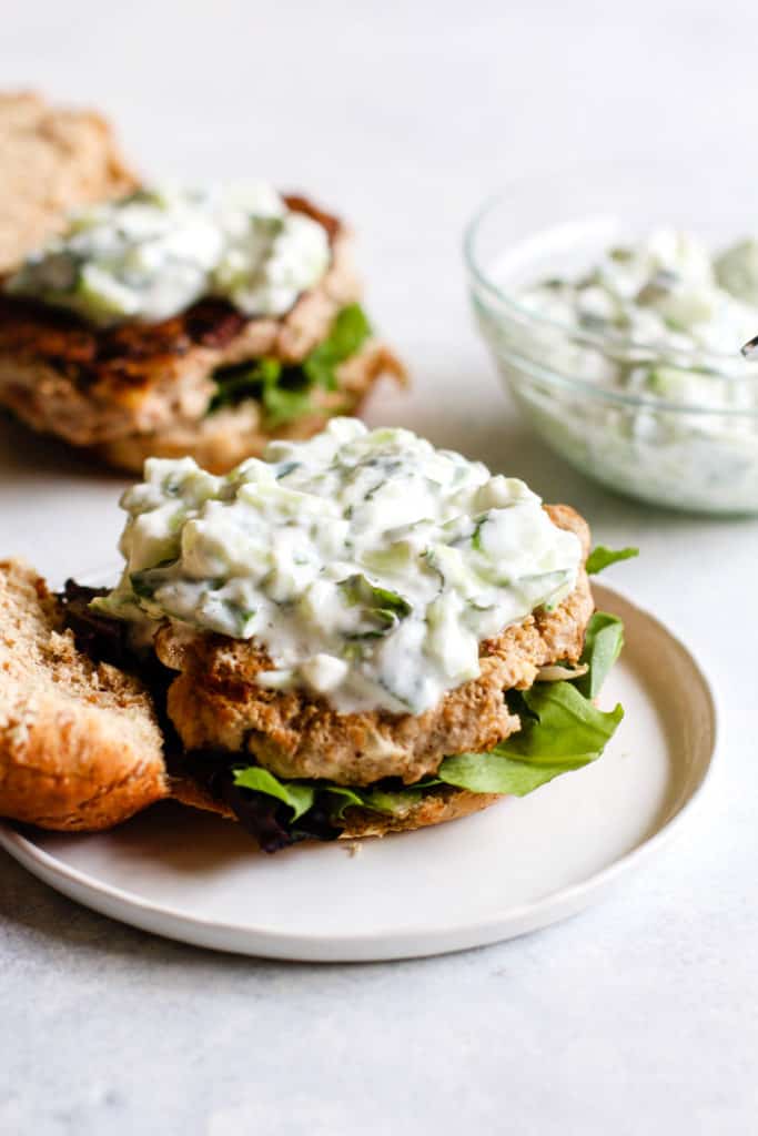 Smoky turkey burger with tzatziki on sprouted grains bun with lettuce and bun still open