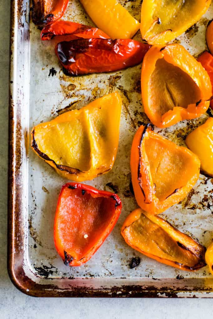 Roasted bell peppers on sheet pan after oven roasting